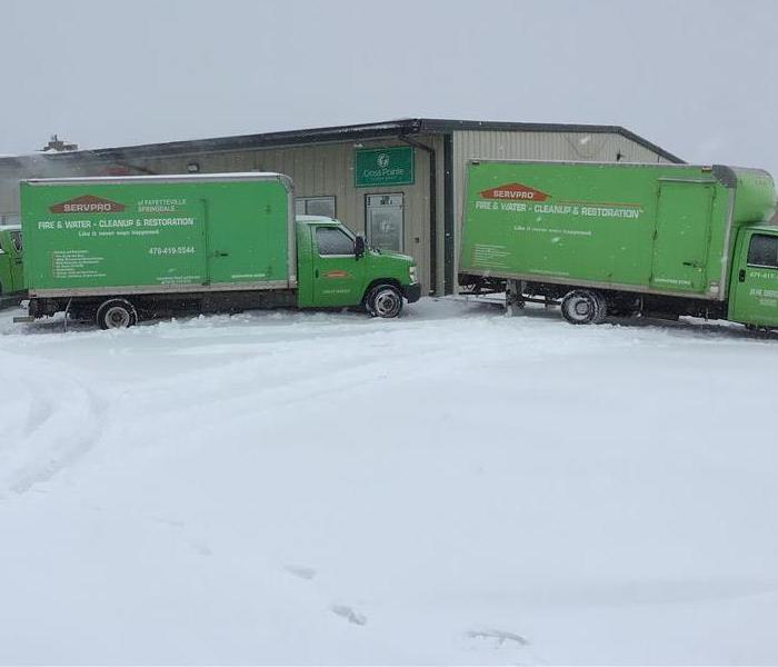 SERVPRO vehicles parked in front of commercial building during snowstorm
